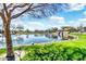 Scenic pond featuring a rock waterfall and lush greenery, reflecting a bright, cloudy sky at 4926 S Hemet St, Gilbert, AZ 85298