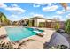 Backyard pool featuring a diving board, concrete surround, and lush landscaping for outdoor enjoyment at 4926 S Hemet St, Gilbert, AZ 85298