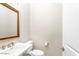 Stylish powder room with decorative mirror, toilet, and vanity with gold fixtures at 4926 S Hemet St, Gilbert, AZ 85298