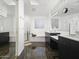 Modern bathroom featuring dual vanities, a soaking tub, and a glass-enclosed shower for a spa-like experience at 5101 N Casa Blanca Dr # 335, Paradise Valley, AZ 85253