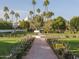 Expansive gardens with a central walkway, fountain and palm trees at 5101 N Casa Blanca Dr # 335, Paradise Valley, AZ 85253