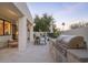 Outdoor living area with stone kitchen island, built-in grill, and covered patio with seating at 5101 N Casa Blanca Dr # 335, Paradise Valley, AZ 85253