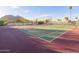 Well-maintained tennis court surrounded by trees and mountain views at 5101 N Casa Blanca Dr # 335, Paradise Valley, AZ 85253