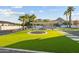 Manicured backyard with a trampoline, pergola with seating, a mountain view, and palm trees at 5601 E Caballo Dr, Paradise Valley, AZ 85253