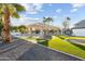 Expansive backyard with lush green lawn, a modern pergola, and desert landscaping with mature palm trees at 5601 E Caballo Dr, Paradise Valley, AZ 85253