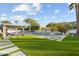 Backyard with a pool, spa, seating area, and pavers surrounded by green grass for a tranquil outdoor space at 5601 E Caballo Dr, Paradise Valley, AZ 85253