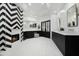 A spacious bathroom with black and white fireplace, dual vanity, and herringbone tile flooring at 5601 E Caballo Dr, Paradise Valley, AZ 85253