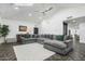 Bright living room with a vaulted ceiling, fireplace, and large gray sectional sofa at 5601 E Caballo Dr, Paradise Valley, AZ 85253