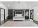 A spacious bedroom with a four-poster bed, dark accent wall, and ample natural light at 5601 E Caballo Dr, Paradise Valley, AZ 85253