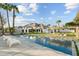 Backyard swimming pool with patio seating, a pergola, palm trees, and grass pavers at 5601 E Caballo Dr, Paradise Valley, AZ 85253