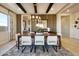 Chic dining room with stylish lighting fixture, wood accent wall, comfortable seating for eight and sophisticated decor at 5711 S Quartz St, Gilbert, AZ 85298