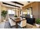 Elegant dining area featuring a chandelier, wood accent wall, seating for eight and plenty of room for entertaining at 5711 S Quartz St, Gilbert, AZ 85298