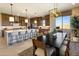 Bright eat-in kitchen featuring wood cabinets, stainless steel appliances, and a large center island with bar seating at 5711 S Quartz St, Gilbert, AZ 85298