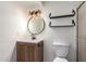 Updated bathroom features woven wood light fixture, floating shelves, and shower at 5809 E Thomas Rd, Scottsdale, AZ 85251