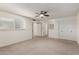 Bright bedroom with a ceiling fan, neutral carpet, and a lattice partition feature at 5809 E Thomas Rd, Scottsdale, AZ 85251