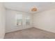 Bedroom featuring neutral carpet, ceiling light, and two windows at 5809 E Thomas Rd, Scottsdale, AZ 85251