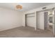 Bedroom featuring neutral carpet, ceiling light and closet at 5809 E Thomas Rd, Scottsdale, AZ 85251