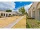 Exterior community view with lush lawns, mature trees, and inviting walkways between units at 5809 E Thomas Rd, Scottsdale, AZ 85251