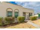 Inviting home exterior showcasing arched windows, green landscaping and a secure gated entryway at 5809 E Thomas Rd, Scottsdale, AZ 85251