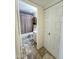 Hallway with tiled floors leading to a neutral, updated bathroom at 5809 E Thomas Rd, Scottsdale, AZ 85251