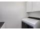 Bright laundry area featuring a modern, front-load washing machine at 5809 E Thomas Rd, Scottsdale, AZ 85251