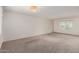 Open living area with plush carpeting, natural light, and a modern light fixture on ceiling at 5809 E Thomas Rd, Scottsdale, AZ 85251