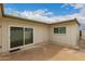 Exterior view of a private patio with sliding glass doors and neutral-colored siding at 5809 E Thomas Rd, Scottsdale, AZ 85251