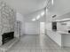 Bright living room featuring tile floors, stone fireplace, and white walls adjacent to the kitchen at 633 W Southern Ave # 1115, Tempe, AZ 85282