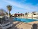 Community pool featuring clear blue water, lounge chairs, and palm trees under a beautiful blue sky at 633 W Southern Ave # 1115, Tempe, AZ 85282