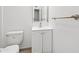 Clean and well-lit bathroom showcasing a white vanity, toilet, and simple mirror at 6808 N 33Rd Ave, Phoenix, AZ 85017