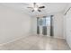 Bright bedroom with tile floors, ceiling fan, curtains, and a white door at 6808 N 33Rd Ave, Phoenix, AZ 85017