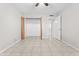 Bedroom featuring tile floors, ceiling fan, and closet with open doors at 6808 N 33Rd Ave, Phoenix, AZ 85017