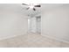 Bedroom with tile floors, ceiling fan, and a closet with a door and shelves at 6808 N 33Rd Ave, Phoenix, AZ 85017