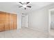 Bedroom featuring tile floors, ceiling fan, and wooden closet doors at 6808 N 33Rd Ave, Phoenix, AZ 85017