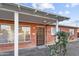 Front view of single story brick house with covered porch, door with security screen and mature landscaping at 6808 N 33Rd Ave, Phoenix, AZ 85017