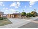 Charming brick home featuring a covered carport and well-maintained landscaping, including trees and grass at 6808 N 33Rd Ave, Phoenix, AZ 85017