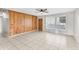 Spacious living room features tile flooring, wood-paneled accent wall, and ample natural light at 6808 N 33Rd Ave, Phoenix, AZ 85017