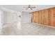 Bright and spacious living area with tile floors, wood-paneled wall, and ceiling fan at 6808 N 33Rd Ave, Phoenix, AZ 85017