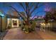 Outdoor space featuring potted plants, brick patio and an open entrance to the interior at twilight at 7334 N 7Th Ave, Phoenix, AZ 85021