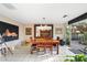 Elegant dining room featuring a large mirror reflecting the space and an outdoor view through sliding glass doors at 7334 N 7Th Ave, Phoenix, AZ 85021