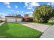 Charming single-story home boasts a large lawn, attached two-car garage, and beautifully manicured landscaping at 7334 N 7Th Ave, Phoenix, AZ 85021