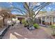 Outdoor patio with a brick floor, seating area, mature tree, and views into the interior of the house at 7334 N 7Th Ave, Phoenix, AZ 85021