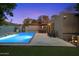 Beautiful pool area with outdoor furniture and landscaped surroundings, illuminated at dusk at 7334 N 7Th Ave, Phoenix, AZ 85021