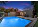 Inviting pool area features outdoor seating, patio, and landscaped backyard at twilight at 7334 N 7Th Ave, Phoenix, AZ 85021