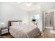 Relaxing bedroom featuring a ceiling fan, a dedicated desk space, and an attached bathroom with tiled floors at 7401 W Arrowhead Clubhouse Dr # 1052, Glendale, AZ 85308