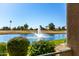 Beautiful lake view with fountain and lush landscaping seen from the home at 7401 W Arrowhead Clubhouse Dr # 1052, Glendale, AZ 85308