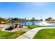 Community pond with a fountain, manicured lawns, and a picnic table, perfect for relaxation at 7401 W Arrowhead Clubhouse Dr # 1052, Glendale, AZ 85308