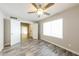 Cozy bedroom featuring a ceiling fan, window with natural light, and hard surface floors at 7559 W Turquoise Ave, Peoria, AZ 85345