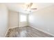 This bedroom features a ceiling fan, large window for natural light and hard surface flooring at 7559 W Turquoise Ave, Peoria, AZ 85345