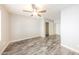 Cozy bedroom featuring wood-look floors, ceiling fan, and closet at 7559 W Turquoise Ave, Peoria, AZ 85345